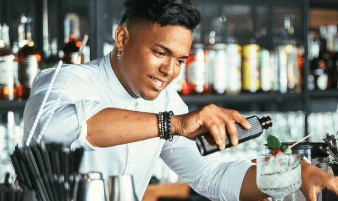 Hospitality Consulting A male bartender serving drinks