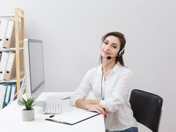 charming-woman-desk-wearing-headset